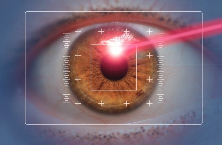 laser eye surgery concept, red laser beam hitting amber eyes